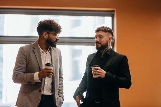 Business colleagues having coffee break conversation - Powered by Adobe