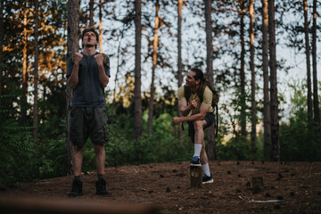 Fototapeta premium Two backpackers stand in a pine forest during a hike, displaying energy and camaraderie.