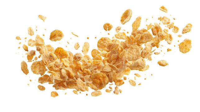 Explosion of golden cornflakes frozen in mid air against a dark background
