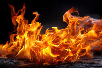 Fototapeta premium Vibrant flames dance against a dark background creating a mesmerizing visual display