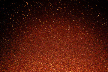 Dark brown textured background glowing from bottom, shimmering particles spread in radiant waves breaking shadows on sides