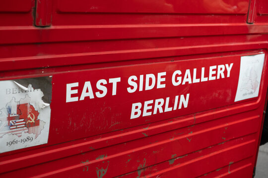 Bold East Side Gallery Sign On Red Vehicle in Berlin, Germany
