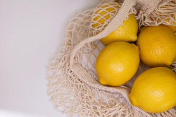 Eco Lifestyle with Lemons in Reusable Mesh Bag – Zero Waste Flat Lay on White Background
