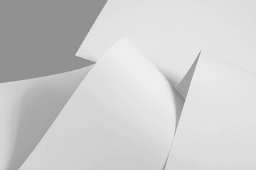 Chaotically folded sheets of white paper in black and white as a background.