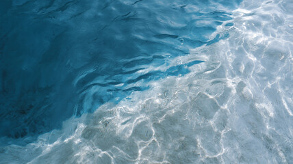 Top flat view of clear water with ripples, sunlight reflecting on blue and white surface, creating calm and refreshing natural texture background