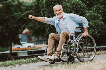 Fototapeta premium funny moment grandpa in wheelchair joins family walk in park spreading joy and positive energy for a bright day