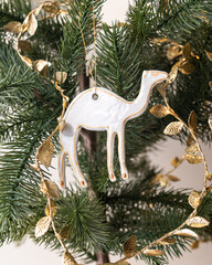 Handmade porcelain Christmas ornaments on a Christmas tree 