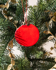 Handmade porcelain Christmas ornaments on a Christmas tree 