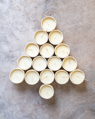 Handmade scented candles in ceramic vessels in a Christmas display