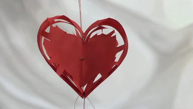 conceptual representation for the romantic festival involving a crimson cardiac silhouette form carefully excised from