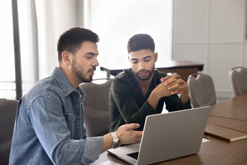 Manager presenting information on laptop to client
