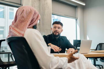 Fototapeta premium Middle eastern and european businessmen discussing new strategies
