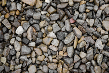 Natural stones background with mixed textures and colors.