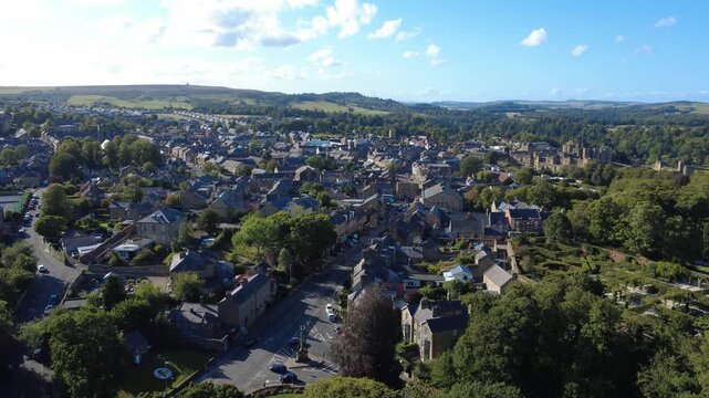 Scenic high aerial view of the town of Alnwick in Northumberland showing the town streets and buildings surrounded by countryside