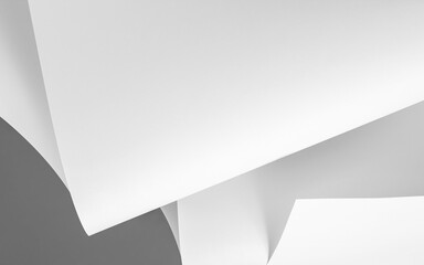 Chaotically folded sheets of white paper in black and white as a background.