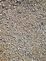 Gravel texture with stones of various sizes against a neutral background for design use and text placement