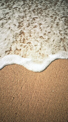 Beach Sand and Ocean Waves Close Up - Nature Background Texture