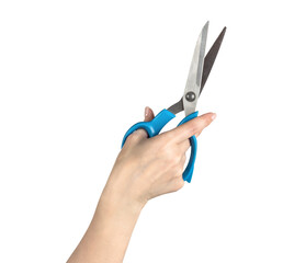A woman’s hand holding open scissors with blue handle, lifted upward on transparent background, symbolizing cutting, choice, precision, or creative action.