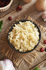 Fermented cabbage or sauerkraut in a black bowl