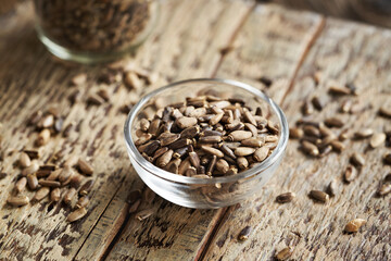 Milk thistle seeds in a glass bowl - ingredient for liver detox
