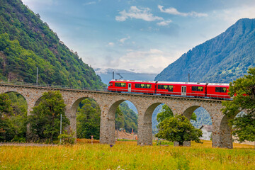 Bernina Express glides from Tirano to St. Moritz, treating passengers to panoramic alpine landscapes and charming villages. Stunning views make this one of the most scenic train journeys in the world © johnkruger1