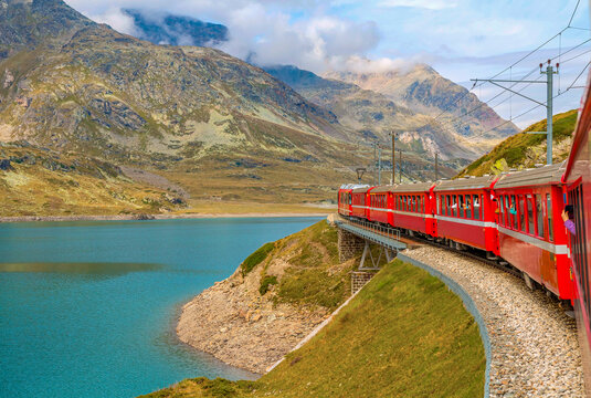 Bernina Express glides from Tirano to St. Moritz, treating passengers to panoramic alpine landscapes and charming villages. Stunning views make this one of the most scenic train journeys in the world