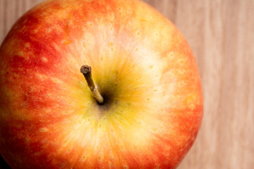 close up red apple on a wooden table