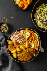 Enjoy a colorful and nutritious breakfast with baked sweet potato, carrots, zucchini, chicken breast, lentil cutlets, fresh salad