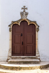 Gothic Geometry: Ornate Lobed Archway Framing Simple Wooden Double Doors of Santa María del Castillo Church, Olivenza.