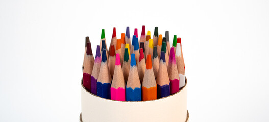 Round cup filled with colorful pencils viewed from above on white background. Perfect for back-to-school, creativity, or design visuals. High quality photo