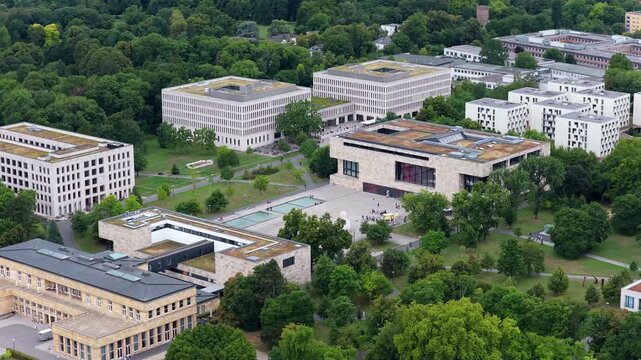 Aerial perspective of modern Westend Campus of Goethe University in Frankfurt, Germany. Lush green parks surrounding contemporary buildings