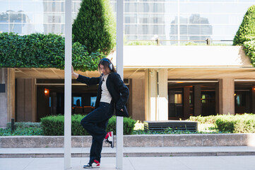 Woman dancing urban style with headphones