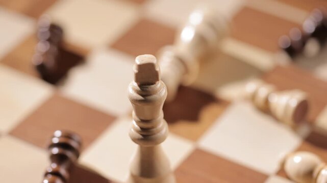 Abstract Close-up of Chess King among Scattered Pieces Showing the Symbolic Struggle of Dominance, Focus, Control - a Metaphor for Victory, Discipline, and the Will to Succeed Against All Odds