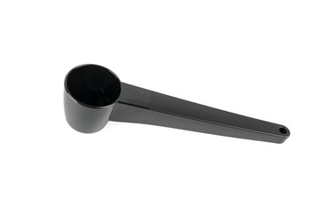 Top-down view of a black plastic measuring scoop isolated on white. Compact and functional design...