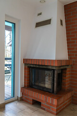 Brick fireplace in modern home interior near terrace door
