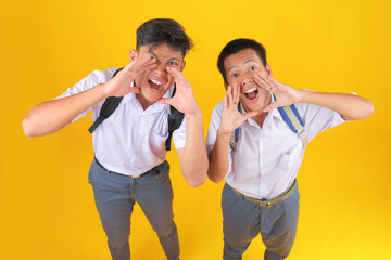 Enthusiastic Students Shouting With Joy Against Vibrant Yellow Backdrop