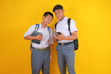 Two Cheerful Students Checking Social Media on Phone