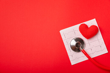 Medical stethoscope, red heart, and cardiogram on a color background. ECG, Heart wave, heart attack, cardiogram report. Cardiogram pulse trace and heart concept. Healthcare.Space for text