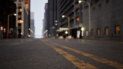 A tranquil city street captured at dawn, showcasing misty buildings rising on either side as soft yellow lines lead into the distance. The early morning light creates an ethereal atmosphere.