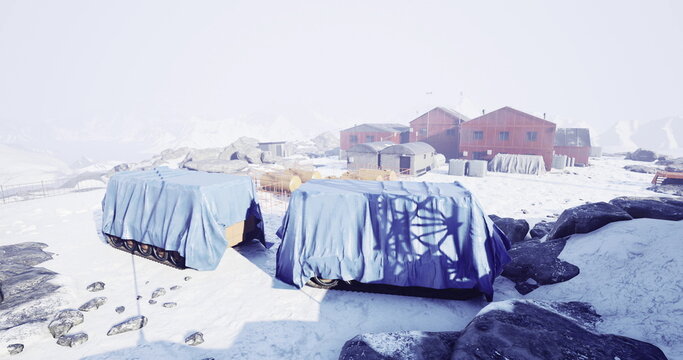In a remote Arctic location, a quaint settlement is blanketed in snow. Blue tarps cover vehicles, while rustic buildings stand resilient against harsh elements, hinting at adventures past.