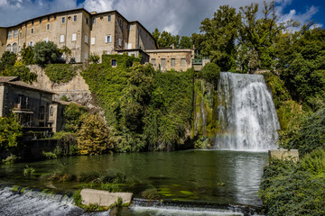 Fototapeta premium Isola del Liri, Frosinone, Lazio, Italy - The village, with its impressive waterfall in the historic center of the city. The river flows past the Boncompagni-Viscogliosi Castle, forming an island.