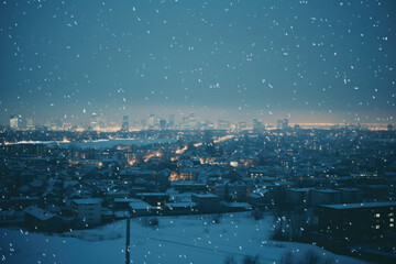 Snowy winter cityscape with illuminated roads and distant skyline