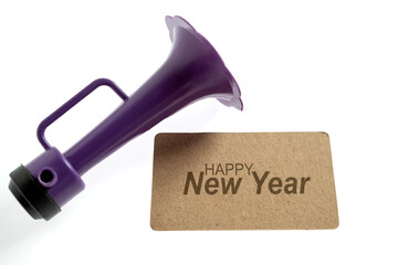 Greeting card of Happy New Year with a plastic horn. Mockup or Copy space. Happy New Year concept...