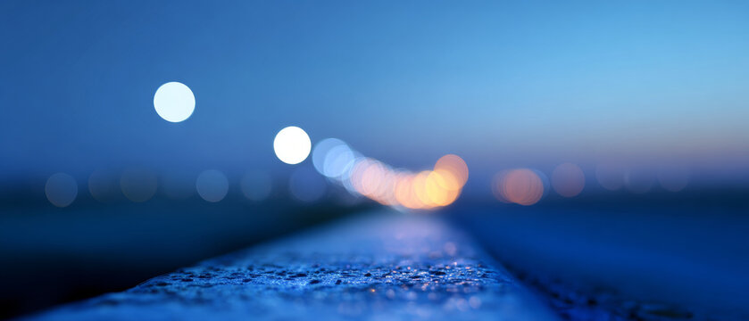 Abstract close-up of textured surface with blurred colorful bokeh lights in blue evening background