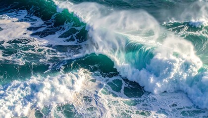 Overhead view of a powerful ocean wave cresting and breaking, revealing shades of turquoise and white foam. The scene captures nature's strength
