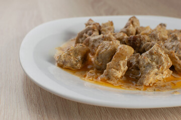 Close-Up of Succulent Chicken Curry Stew on a White Plate for Home-Cooked Cuisine