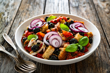 Panzanella salad on wooden table	