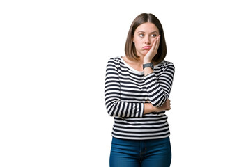 Fototapeta premium Frustrated young woman in black and white striped shirt, resting chin on hand with a bored and pensive expression, looking to the side, isolated on transparent background.