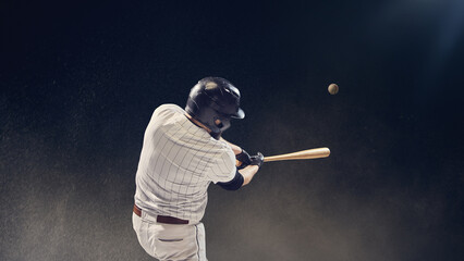 Baseball batter striking ball midair during hit showing timing and reaction focus. Concept of...