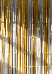 Obraz premium Golden and silver metallic curtain, a symbol of luxury and festivity. Perfect for backgrounds, textures, or festive designs.